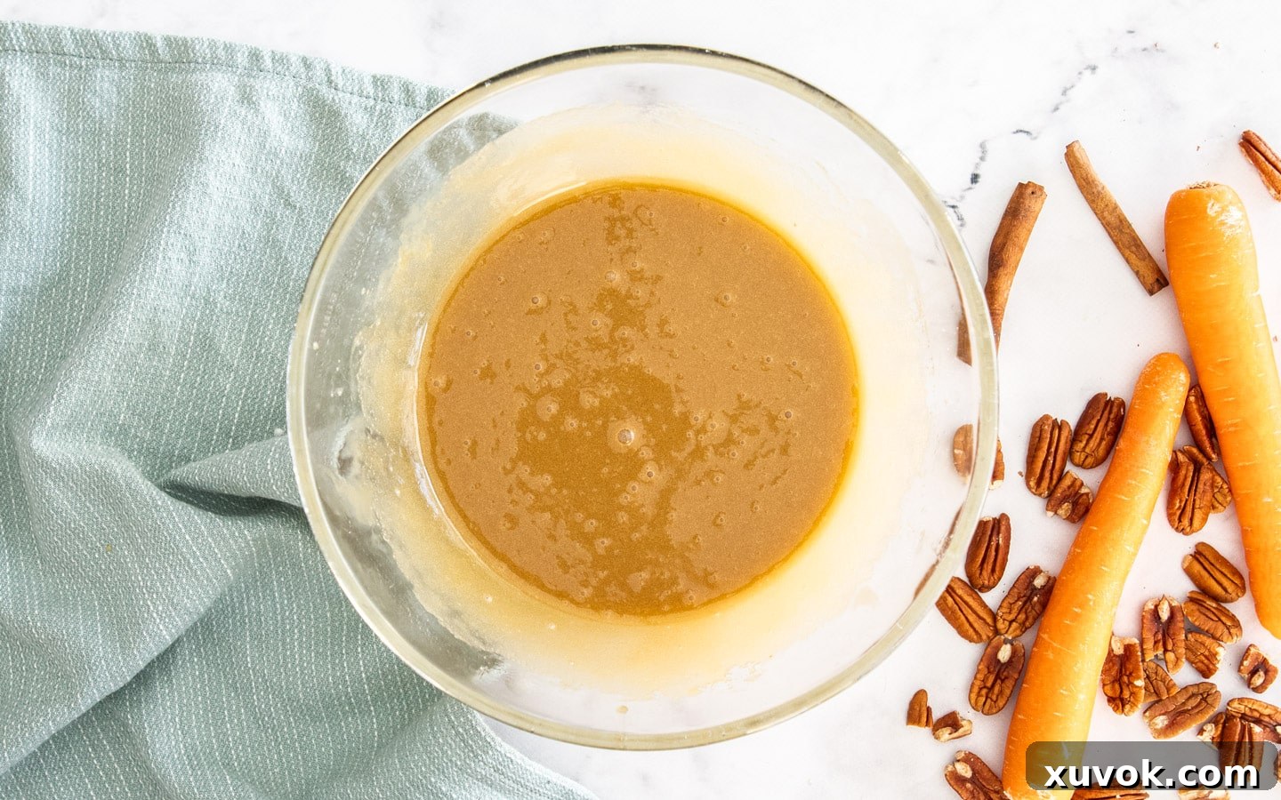 The wet ingredients in a bowl after eggs have been whisked in, showing a smooth and well-emulsified batter.