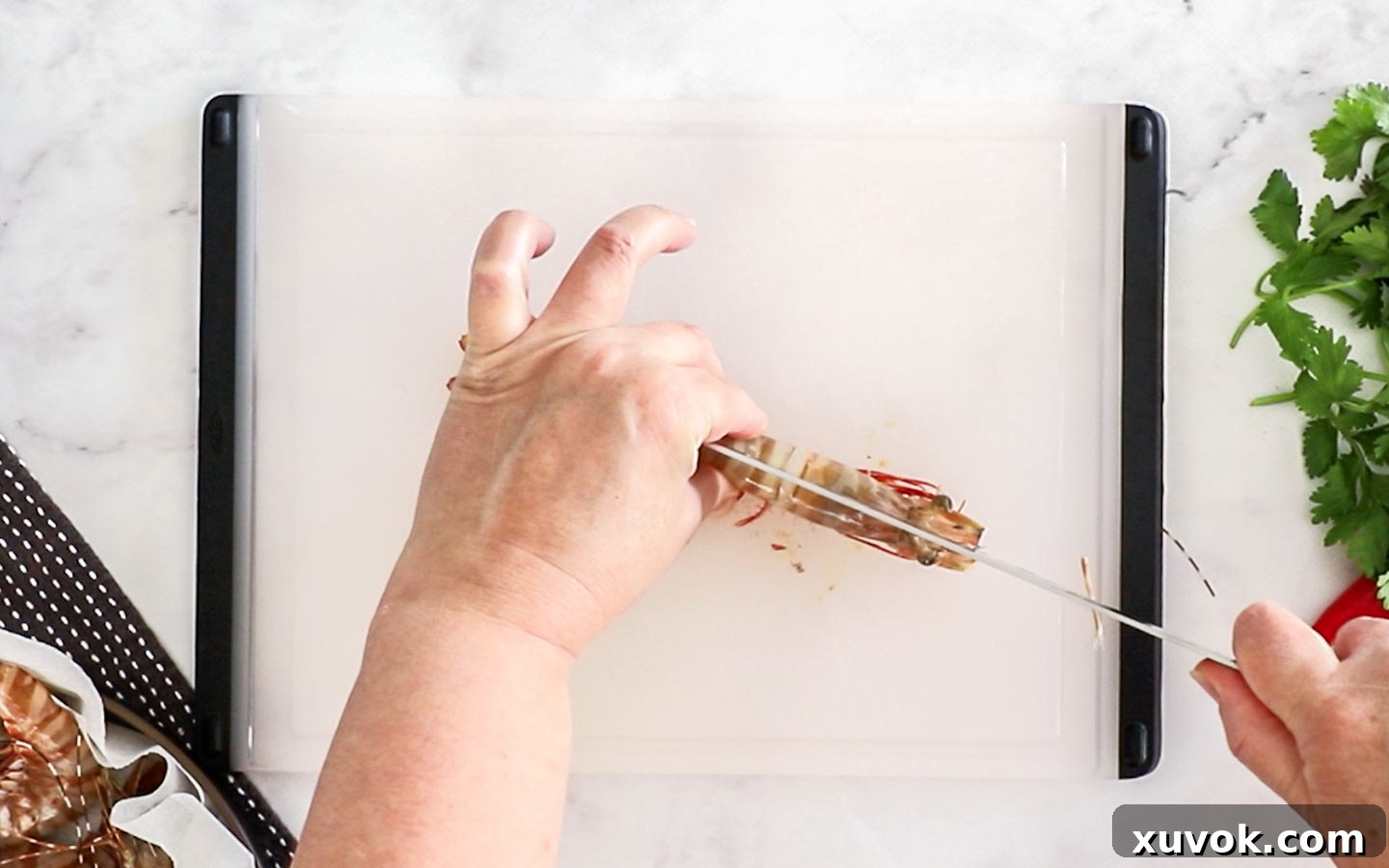 Demonstration of how to slice a prawn for butterflying.
