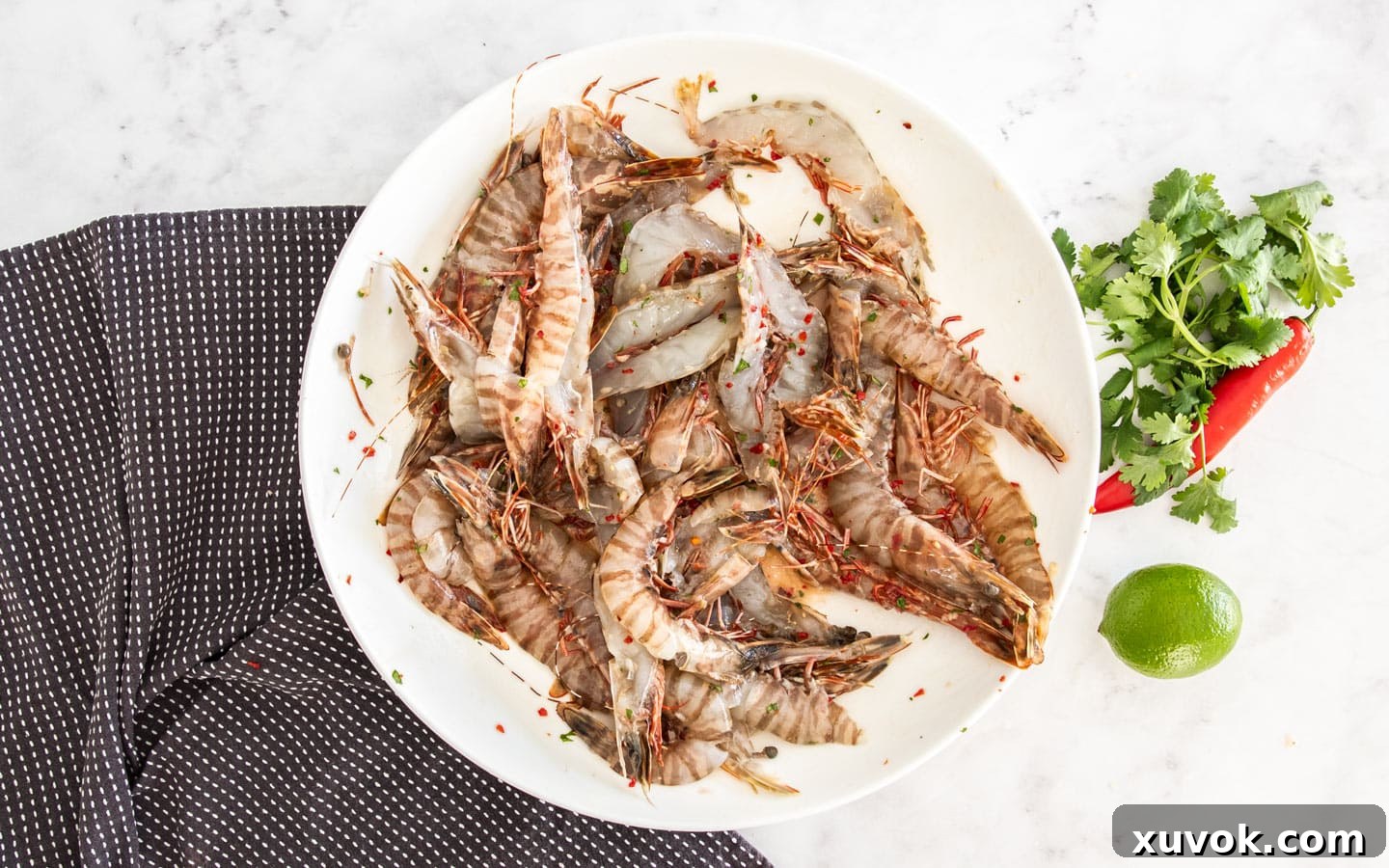 The dressed prawns in a bowl, perfectly marinated and ready to cook.