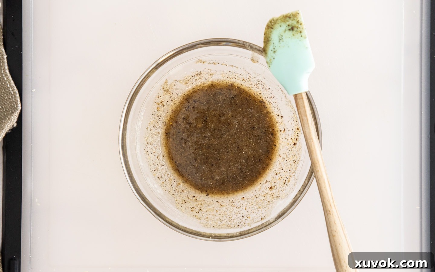 A small bowl holding the oil and spice seasoning mixture, ready for brushing.