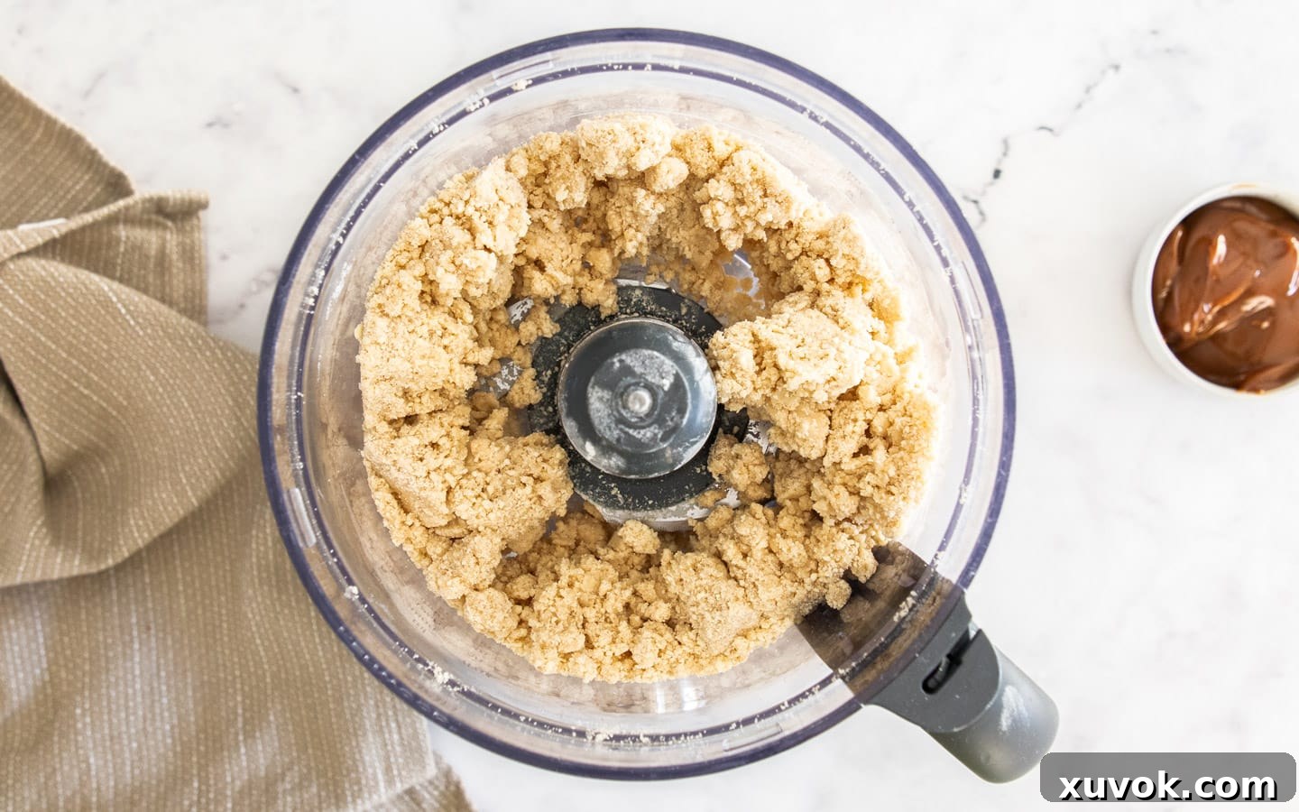The clumping pastry in the food processor, indicating it's ready for shaping.