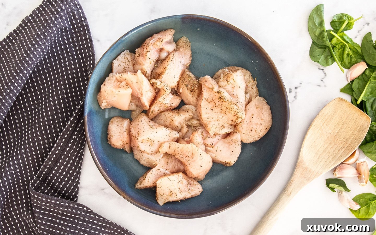 The seasoned chicken pieces in a bowl.