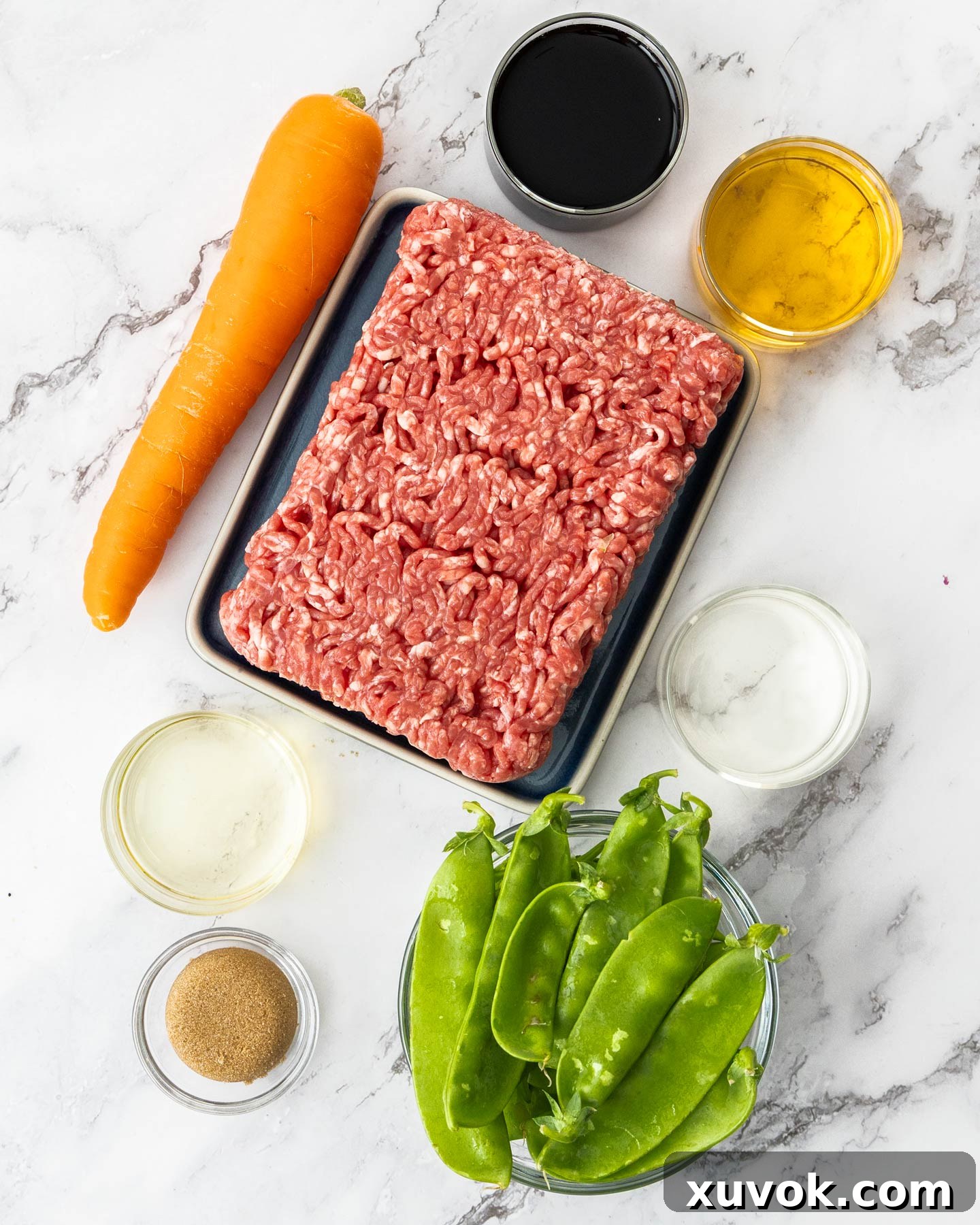 Ingredients for teriyaki beef bowls on a marble surface.
