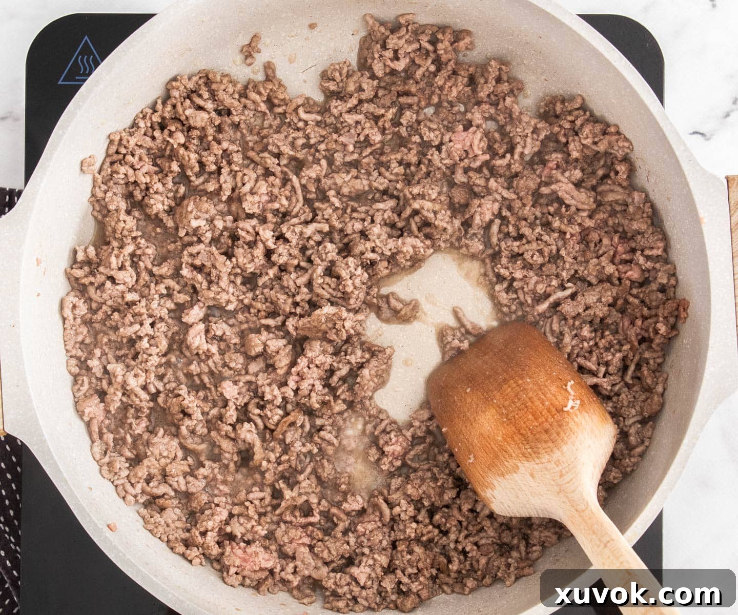 The beef mince cooking in a pan.