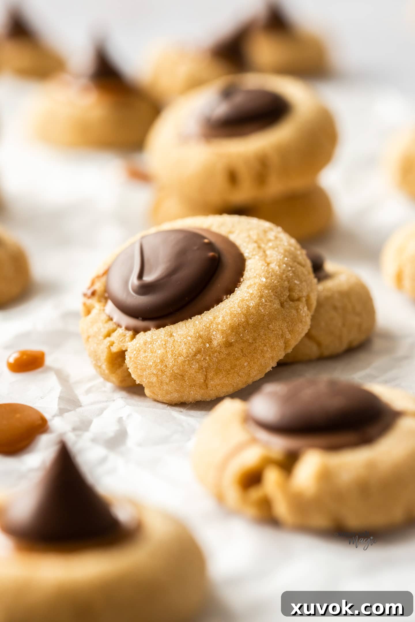 One Caramel Peanut Butter Thumbprint Cookie stacked on an angle on top of another.