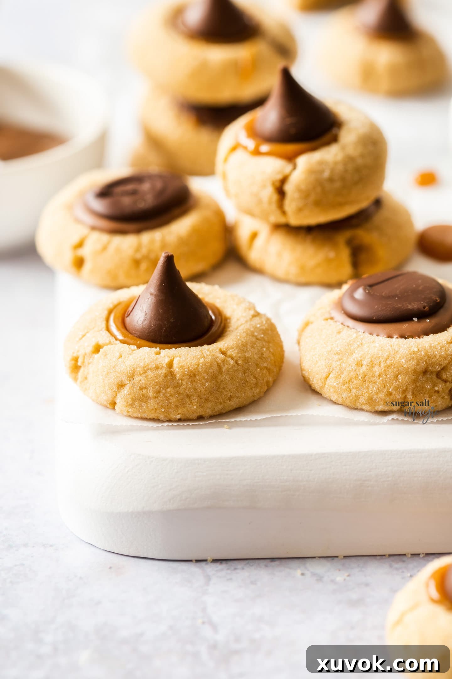 A thumbprint cookie topped with a shiny Hershey's Kiss.