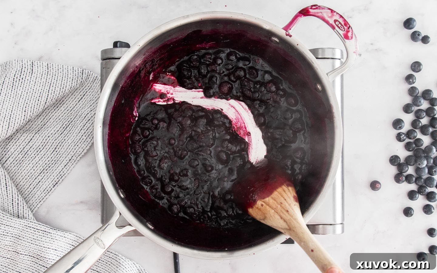 Thickened blueberry jam filling in a saucepan, ready to be cooled.