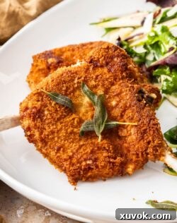 Closeup of the crunchy coating on a pork cotoletta, showing the golden-brown crust.