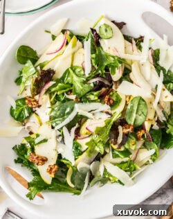 Walnut & pear salad in a white serving platter, beautifully arranged.