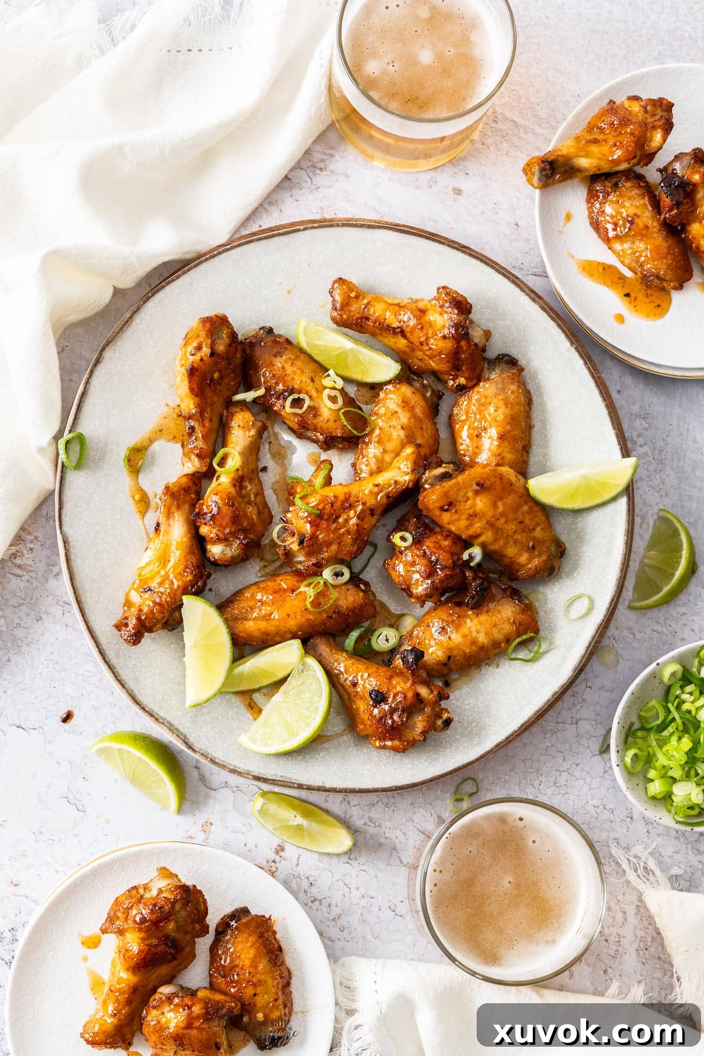 Top down view of a batch of hot honey wings on a plate.