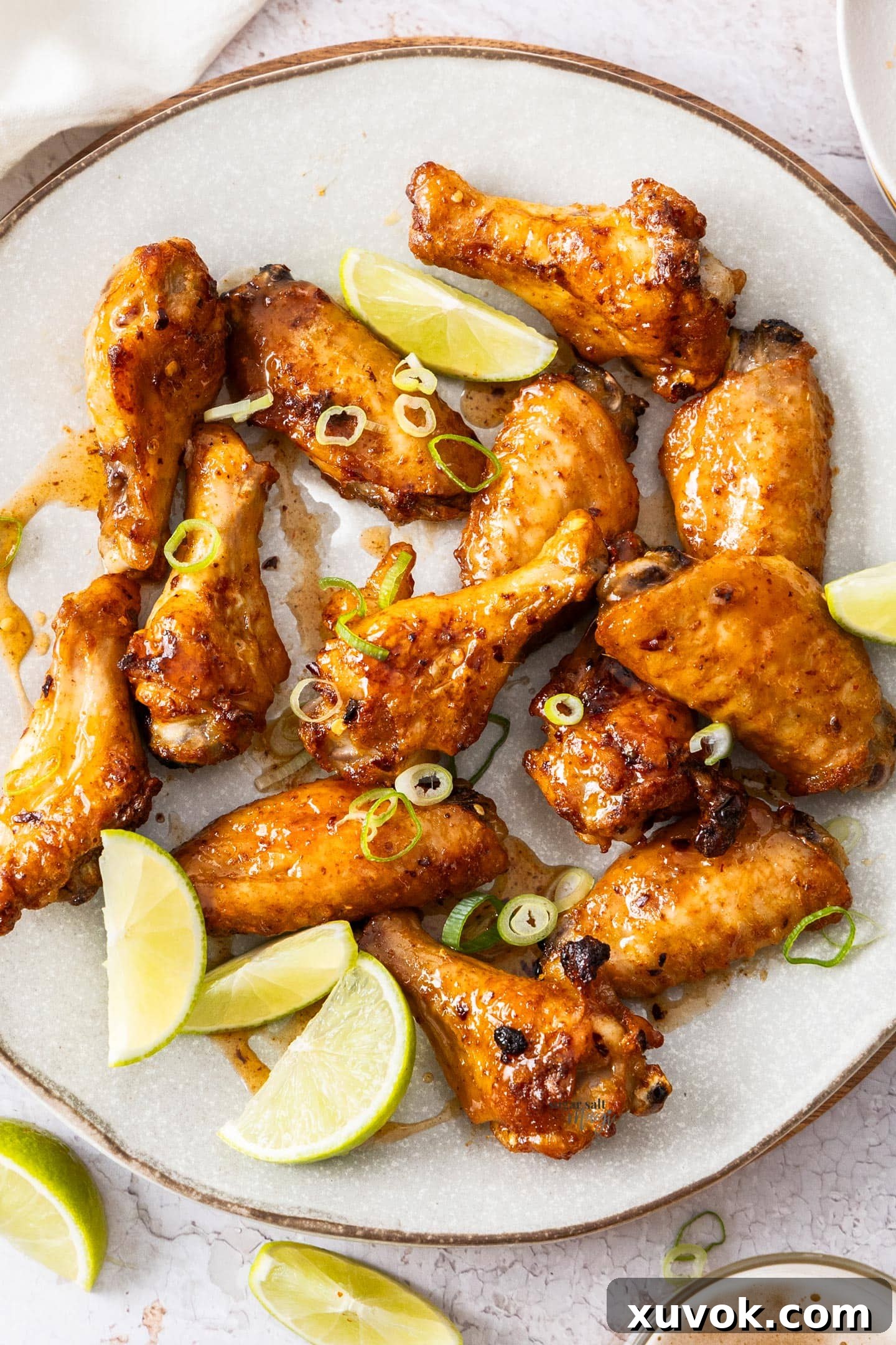 13 hot honey chicken wing pieces on a plate.