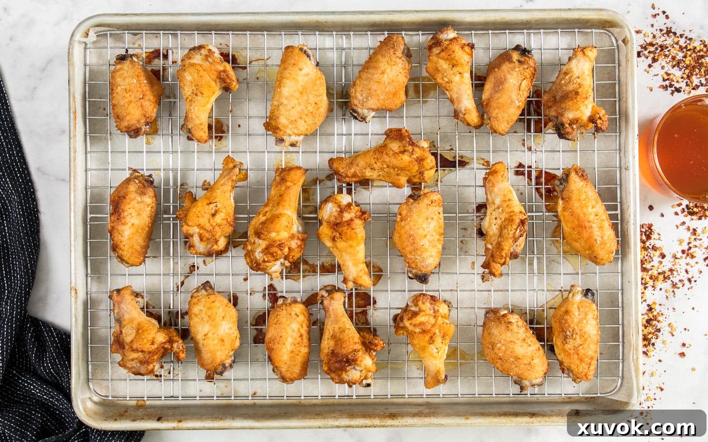 The wings on the baking tray after the first bake.