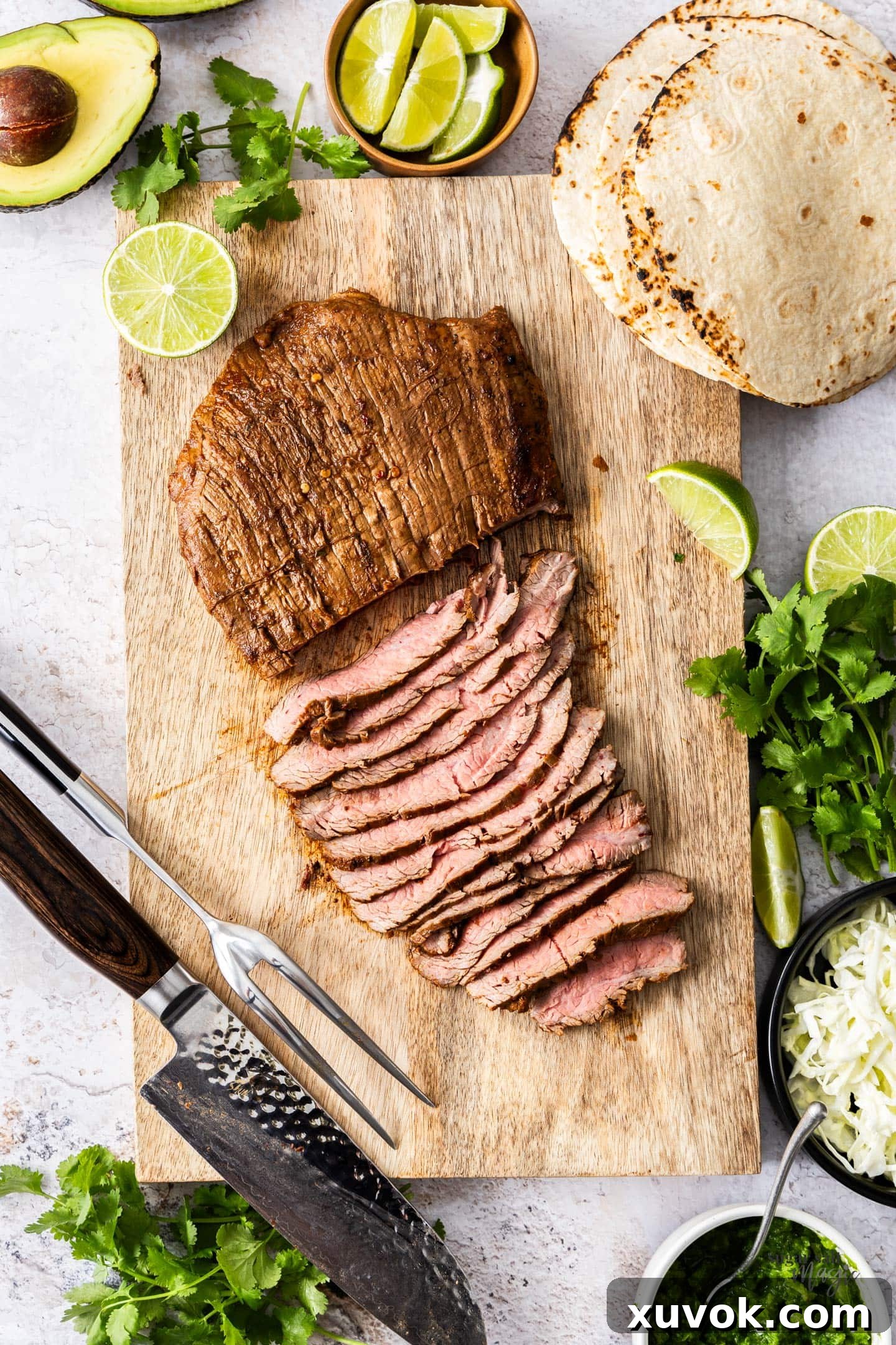 The cooked flank steak on a chopping board.