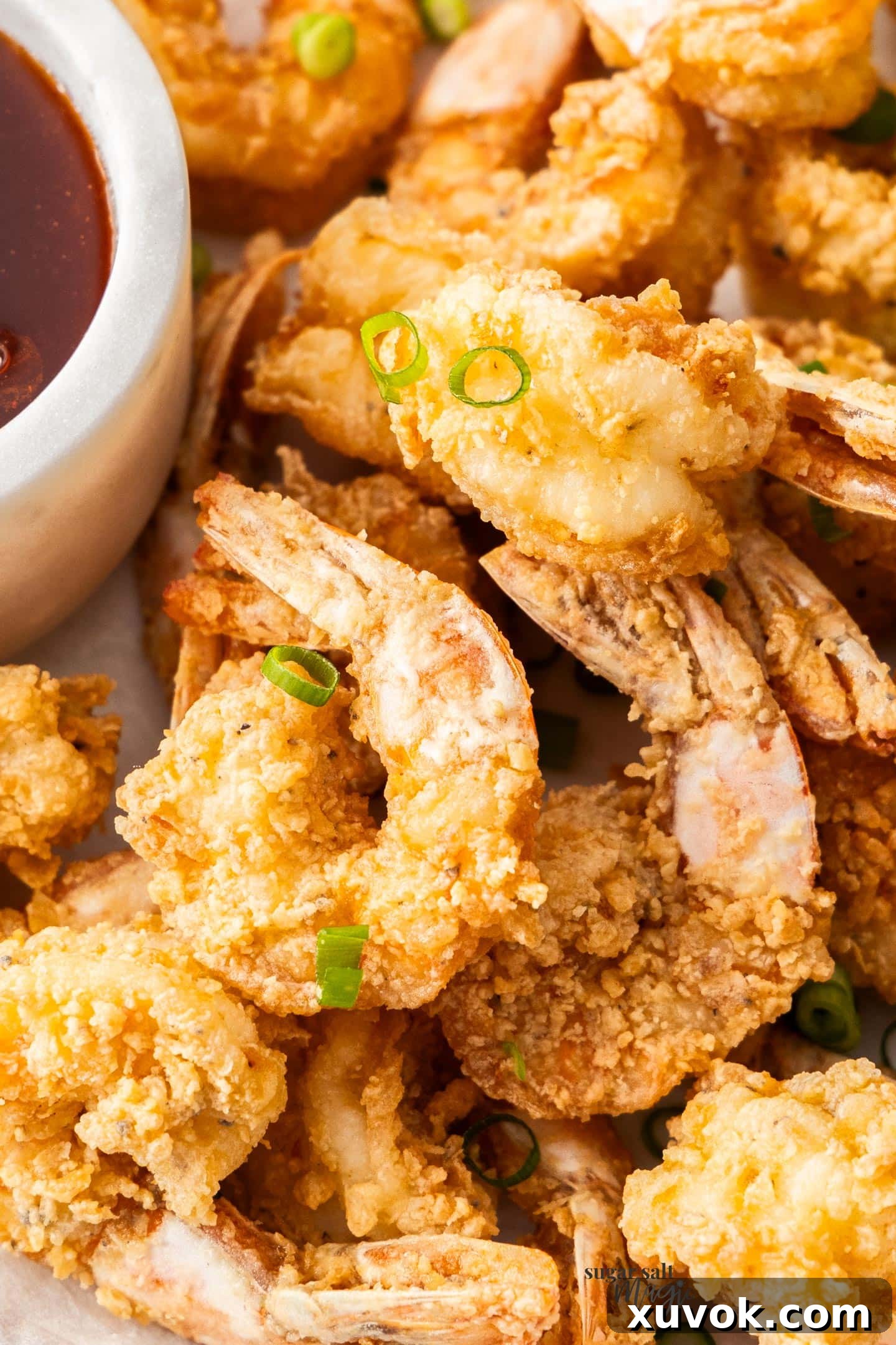 Closeup of a pile of crispy prawns, perfectly golden and crunchy.