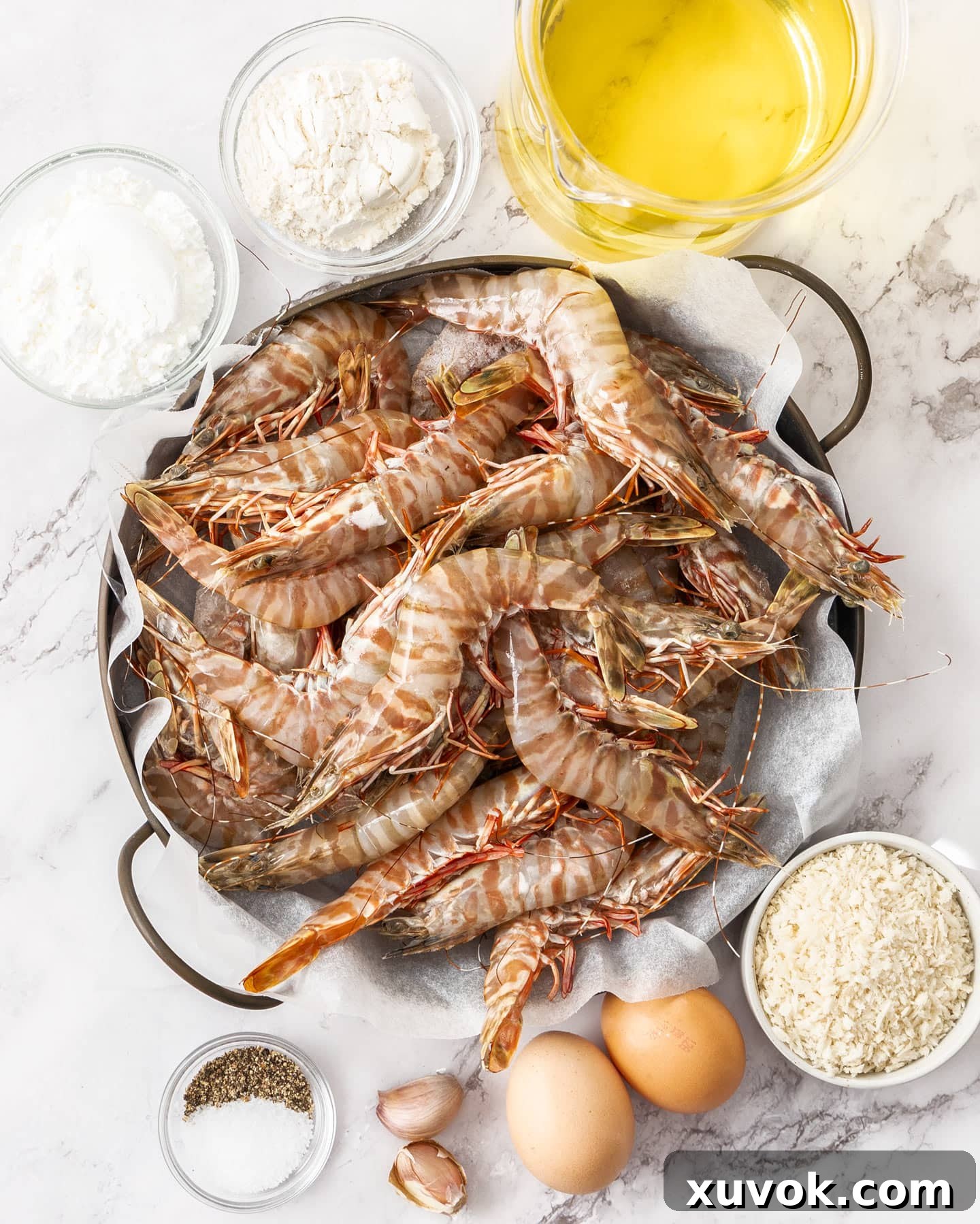 Ingredients for crispy prawns laid out on a marble surface.