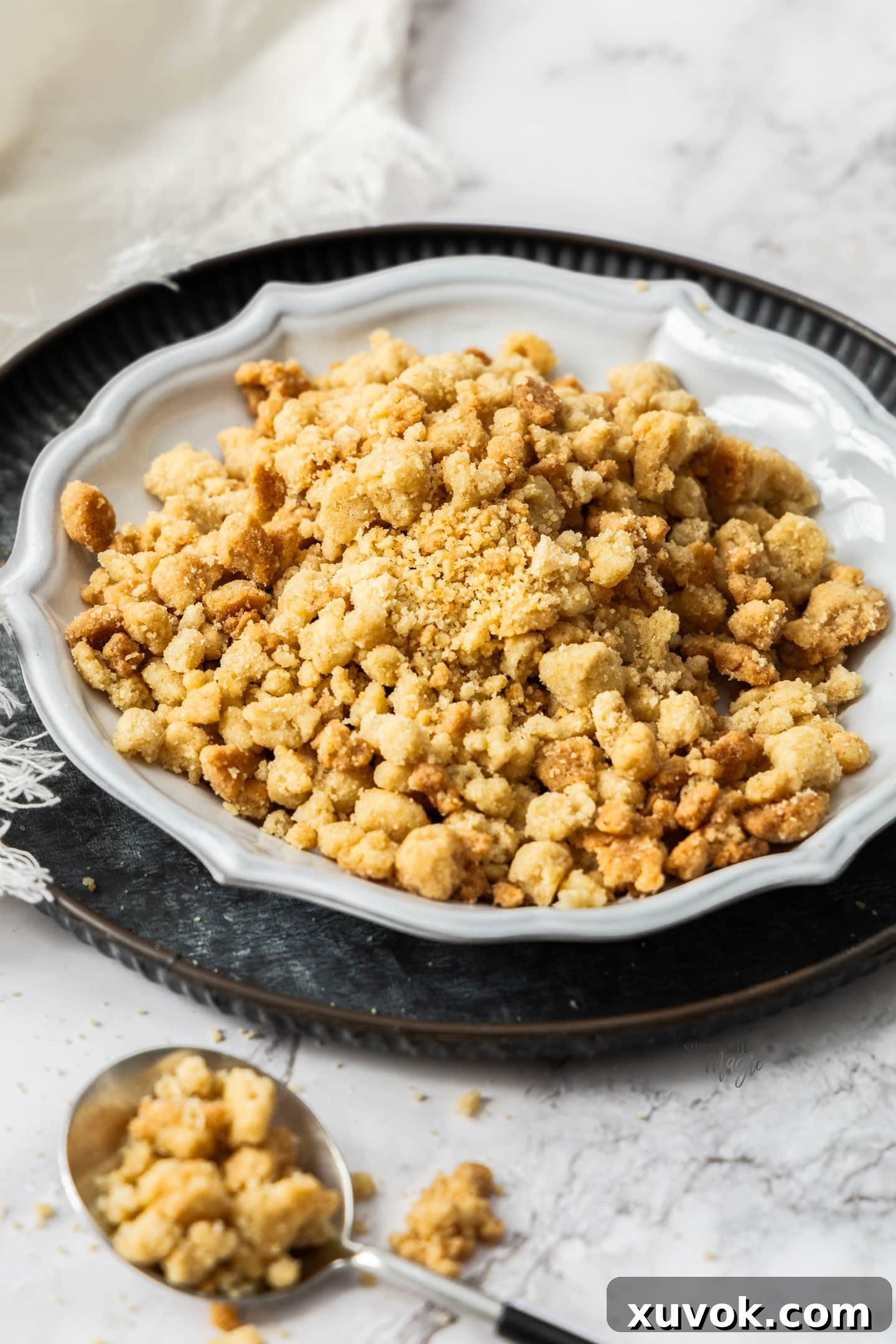 Baked streusel topping on a plate.