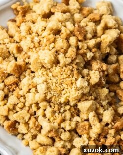 Top down view of a pile of streusel on a decorative plate.