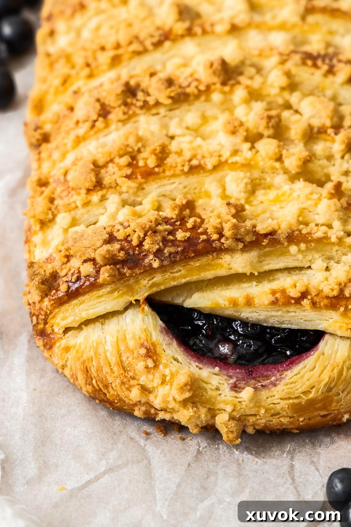 A close-up photograph showcasing the beautifully flaky layers within the homemade Danish pastry, highlighting the success of the lamination process.