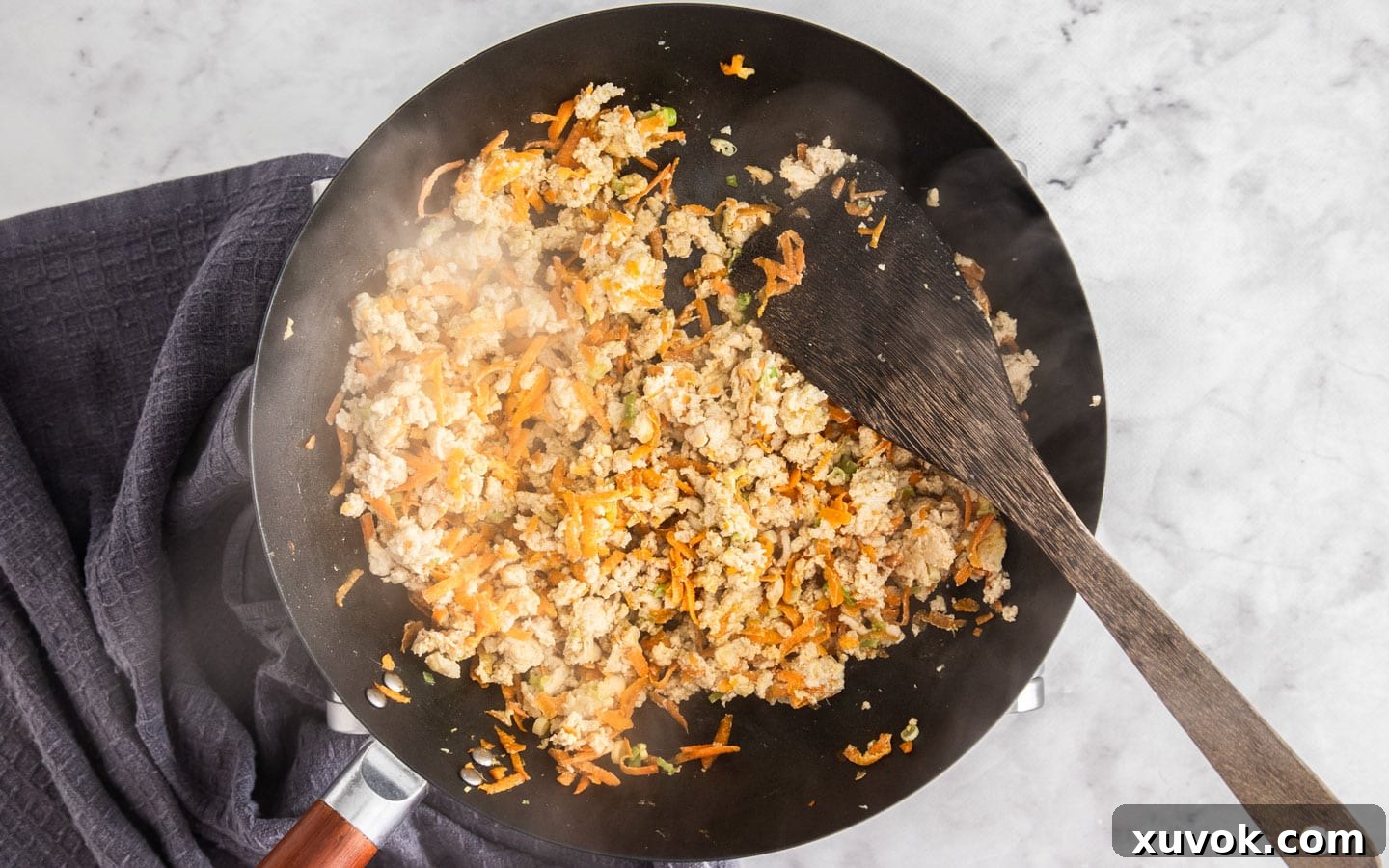 Delicious chicken mince expertly browned in the wok, showing no pink and ready to absorb the rich sauce.
