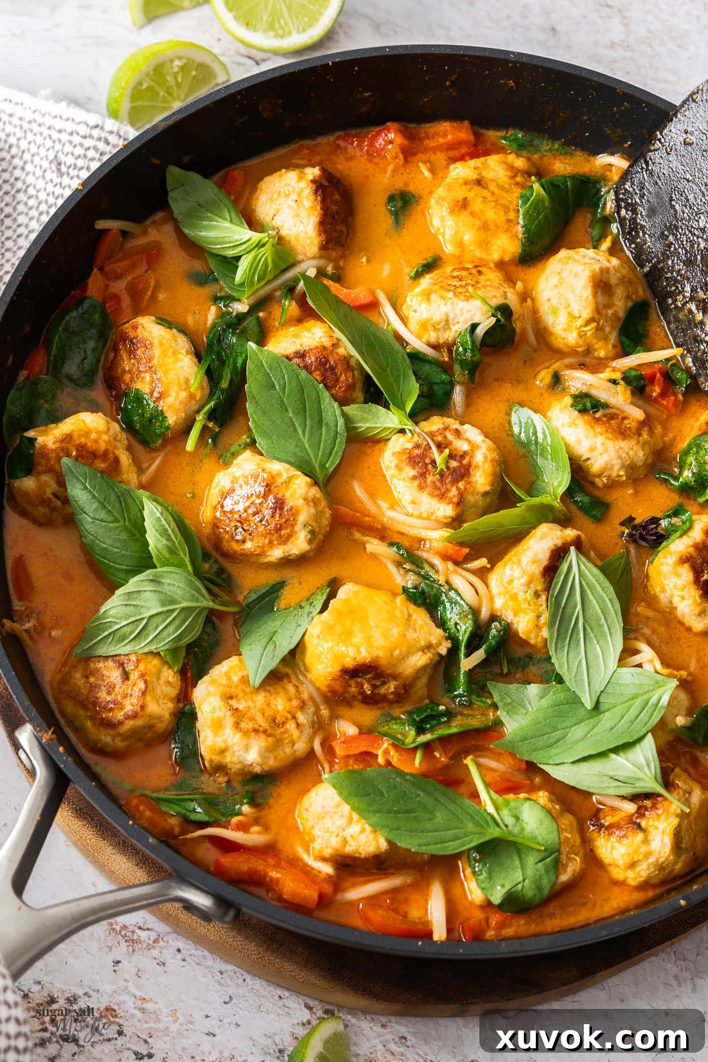 Thai red curry chicken meatballs in a pan, ready to eat.