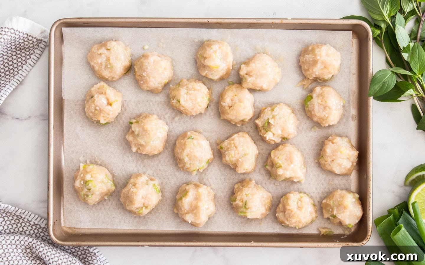 The rolled meatballs on a tray ready to cook.