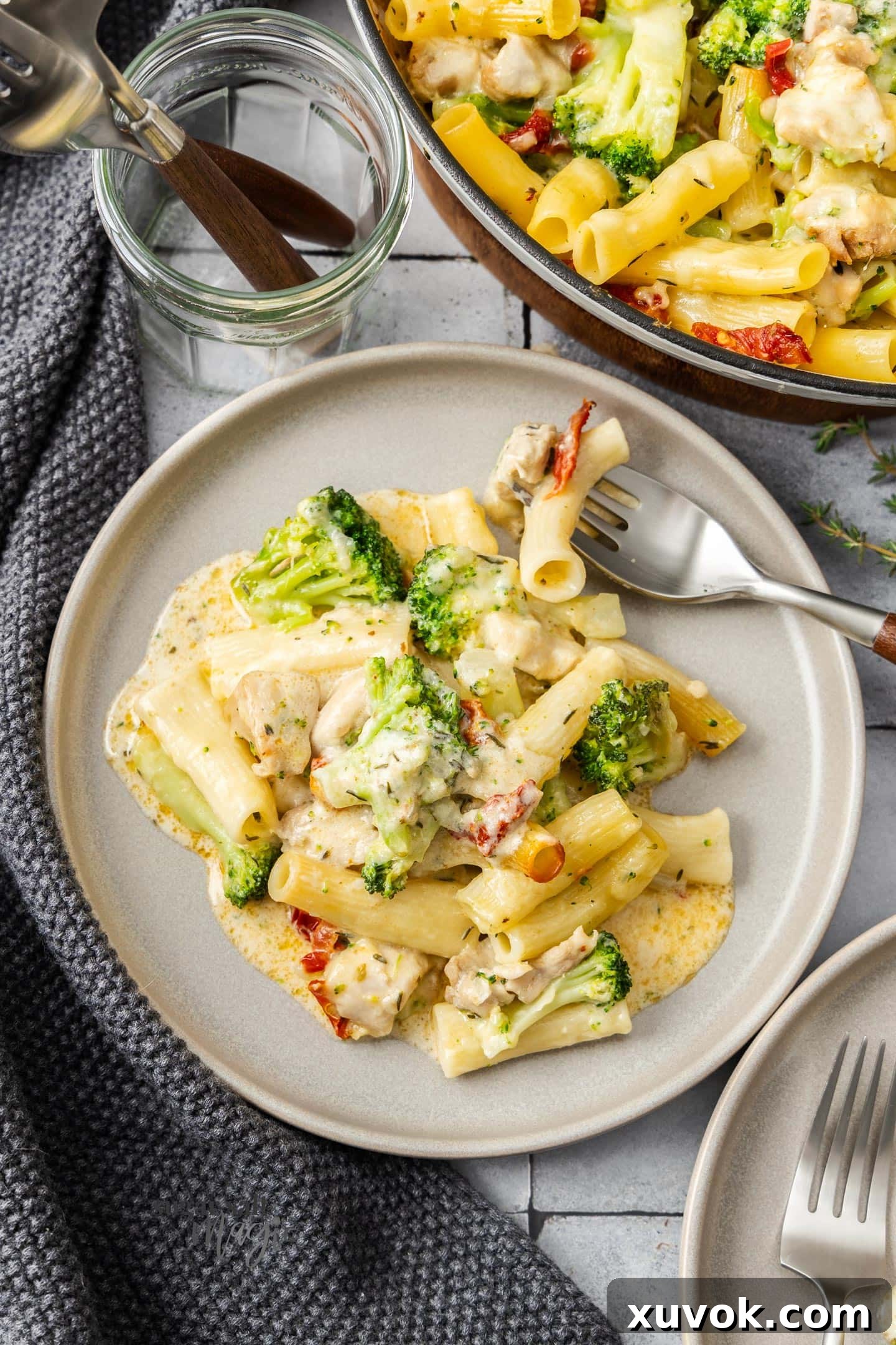 A serving of broccoli and chicken pasta bake on a dinner plate.