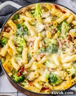 Top down view of chicken broccoli pasta bake in a pan ready to eat.