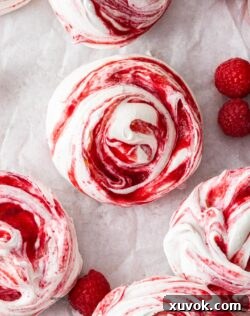 Top down view of a batch of raspberry meringues.