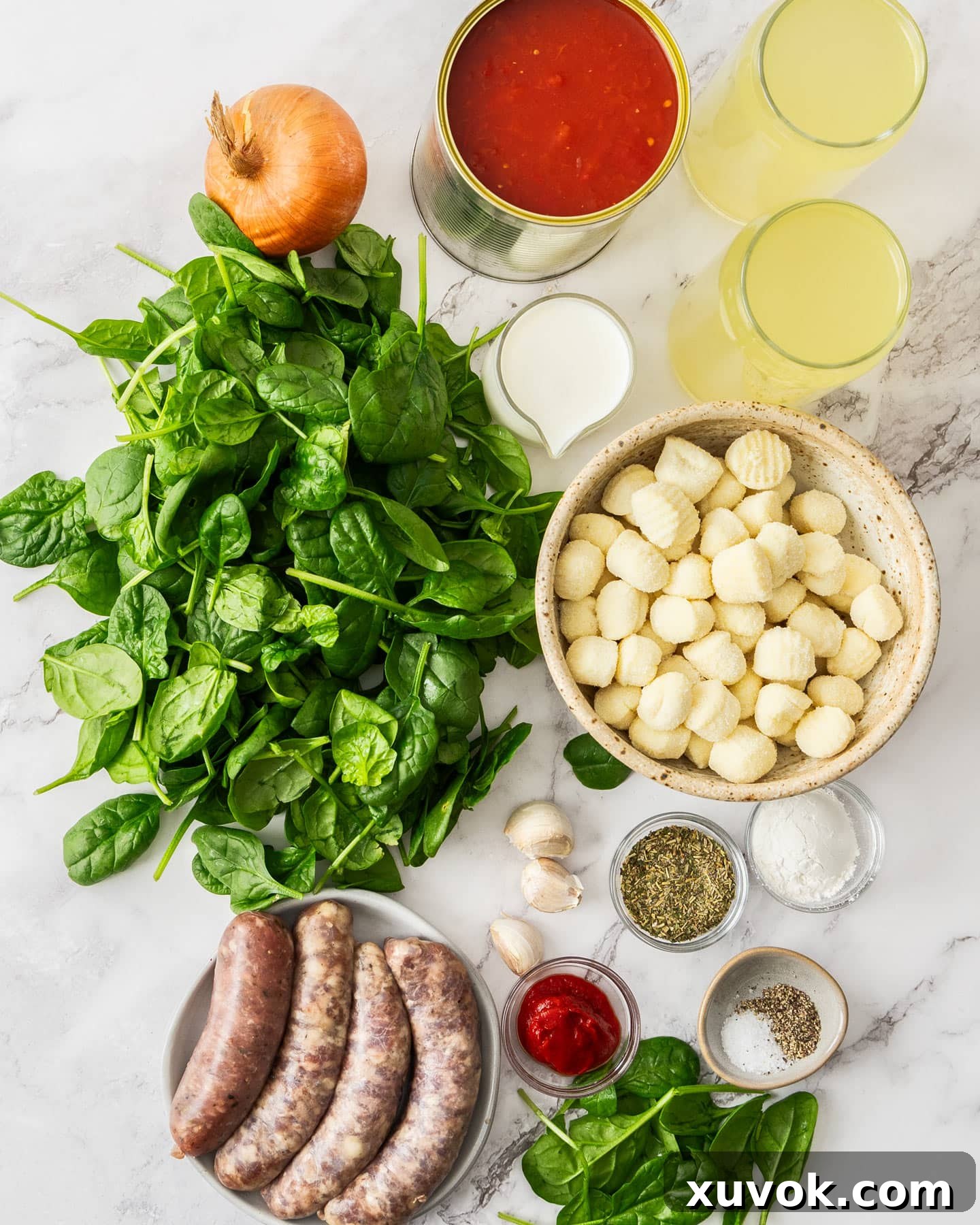 A curated collection of fresh ingredients laid out, ready for making delicious gnocchi and sausage soup.