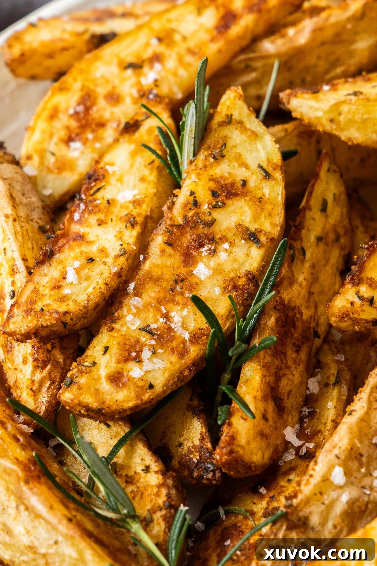 Extreme closeup of a perfectly baked potato wedge, golden and crispy.
