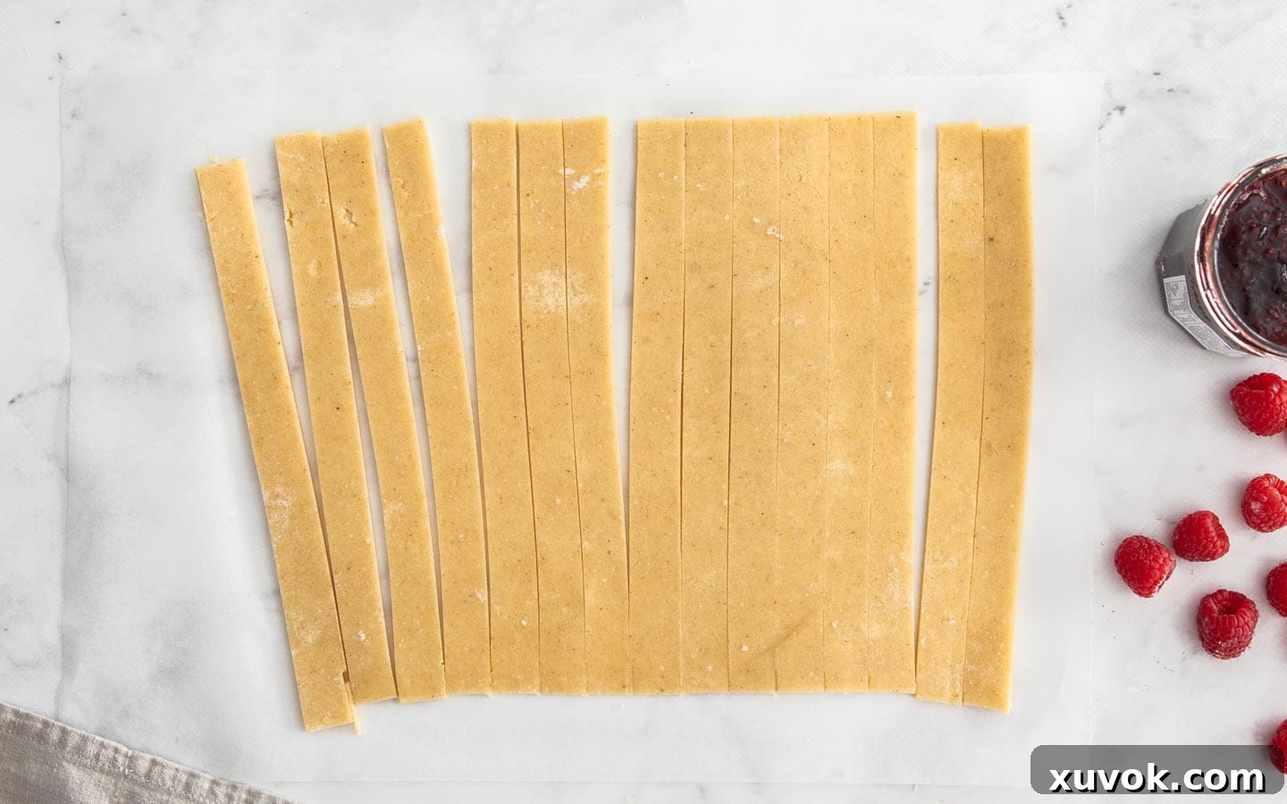 Pastry dough cut into straight strips.