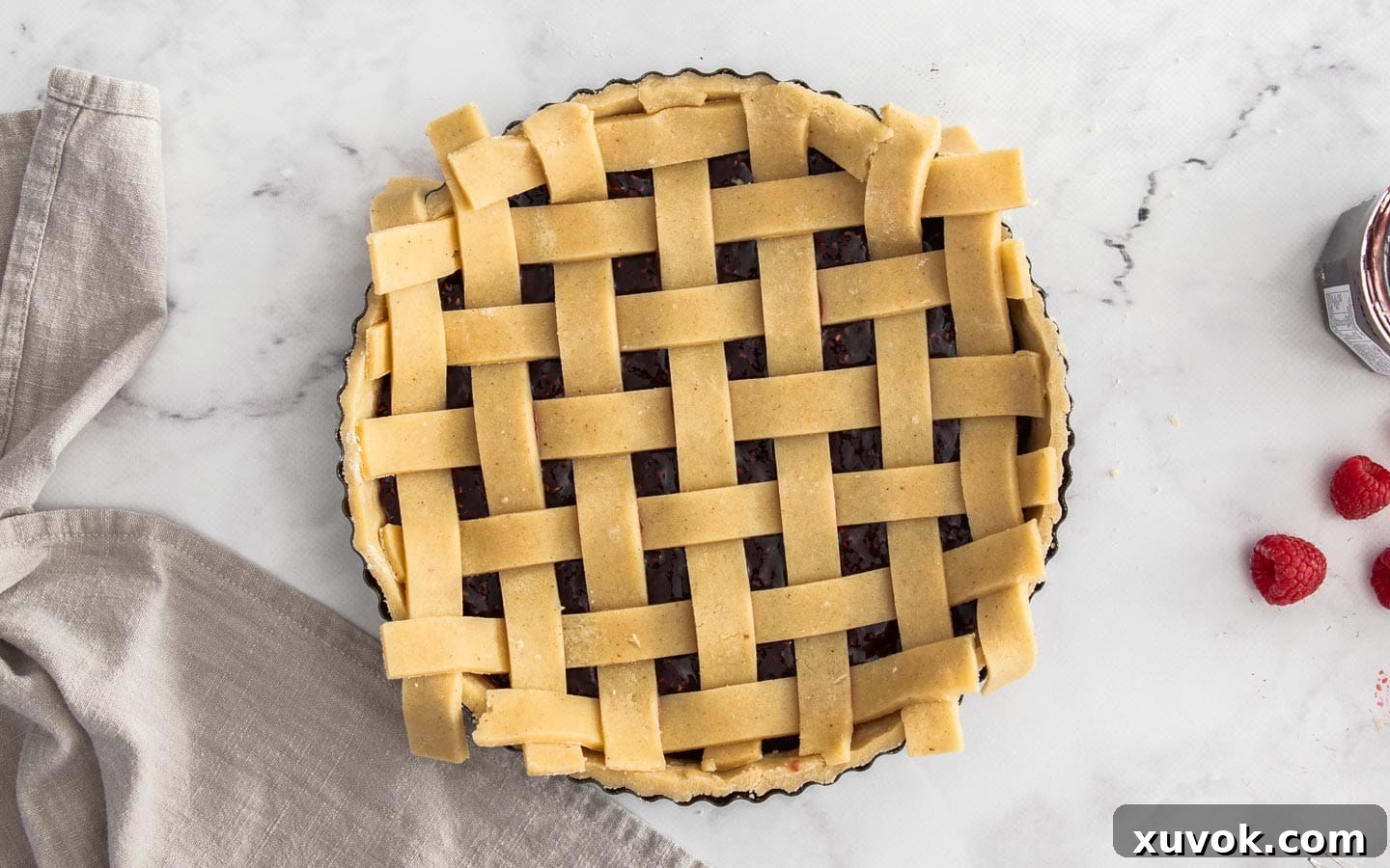 The strips of dough in a lattice design on top of the tart.