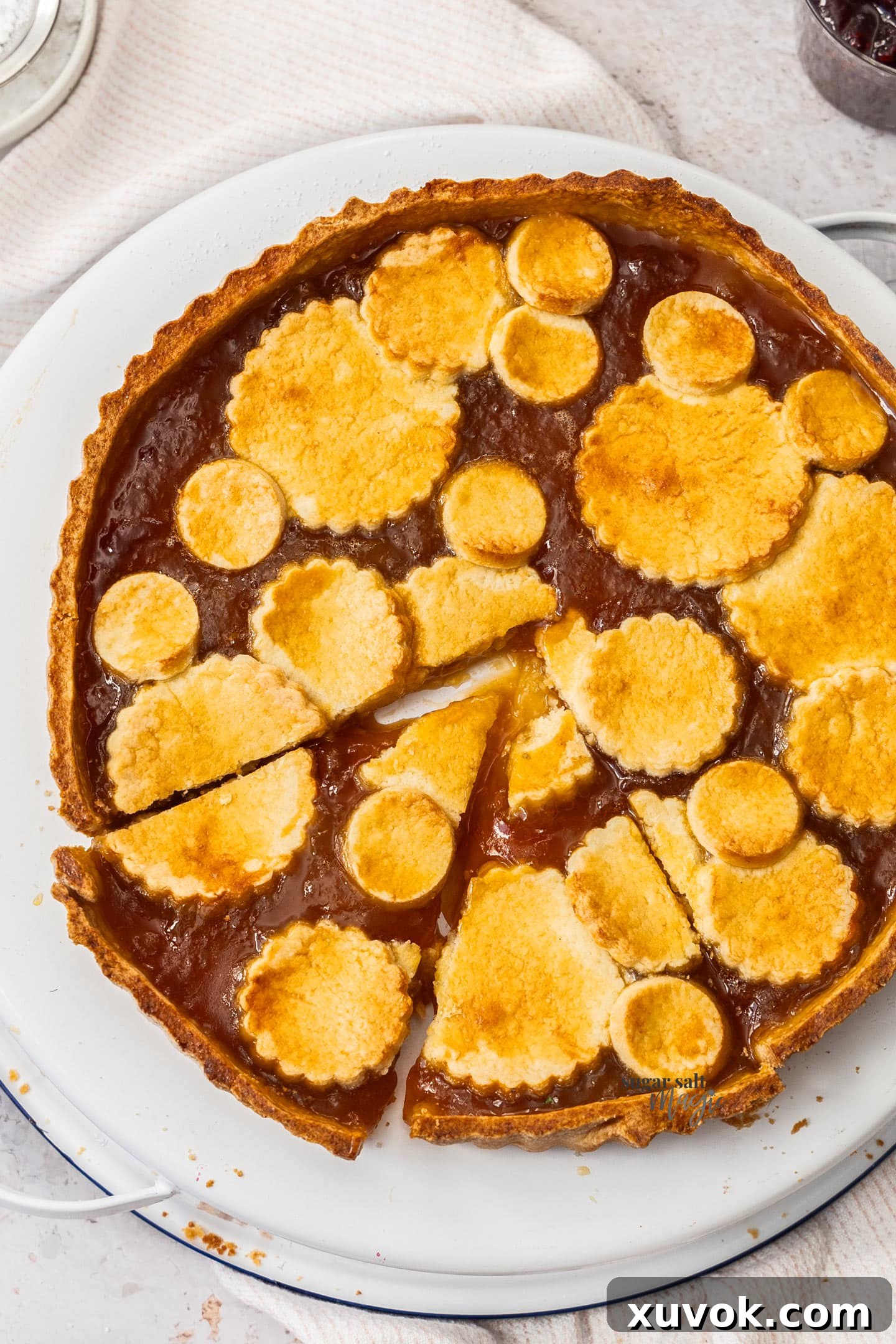 Top down view of linzer tart with circles of dough on top.