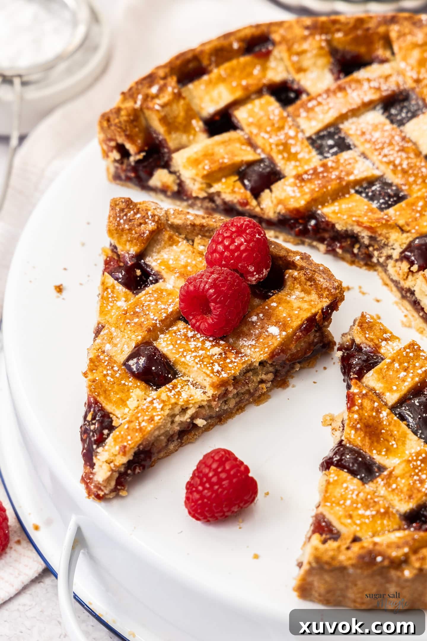 A slice of linzer tart on a platter.