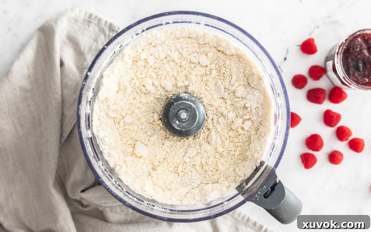 A food processor filled with the pastry mix before adding water.