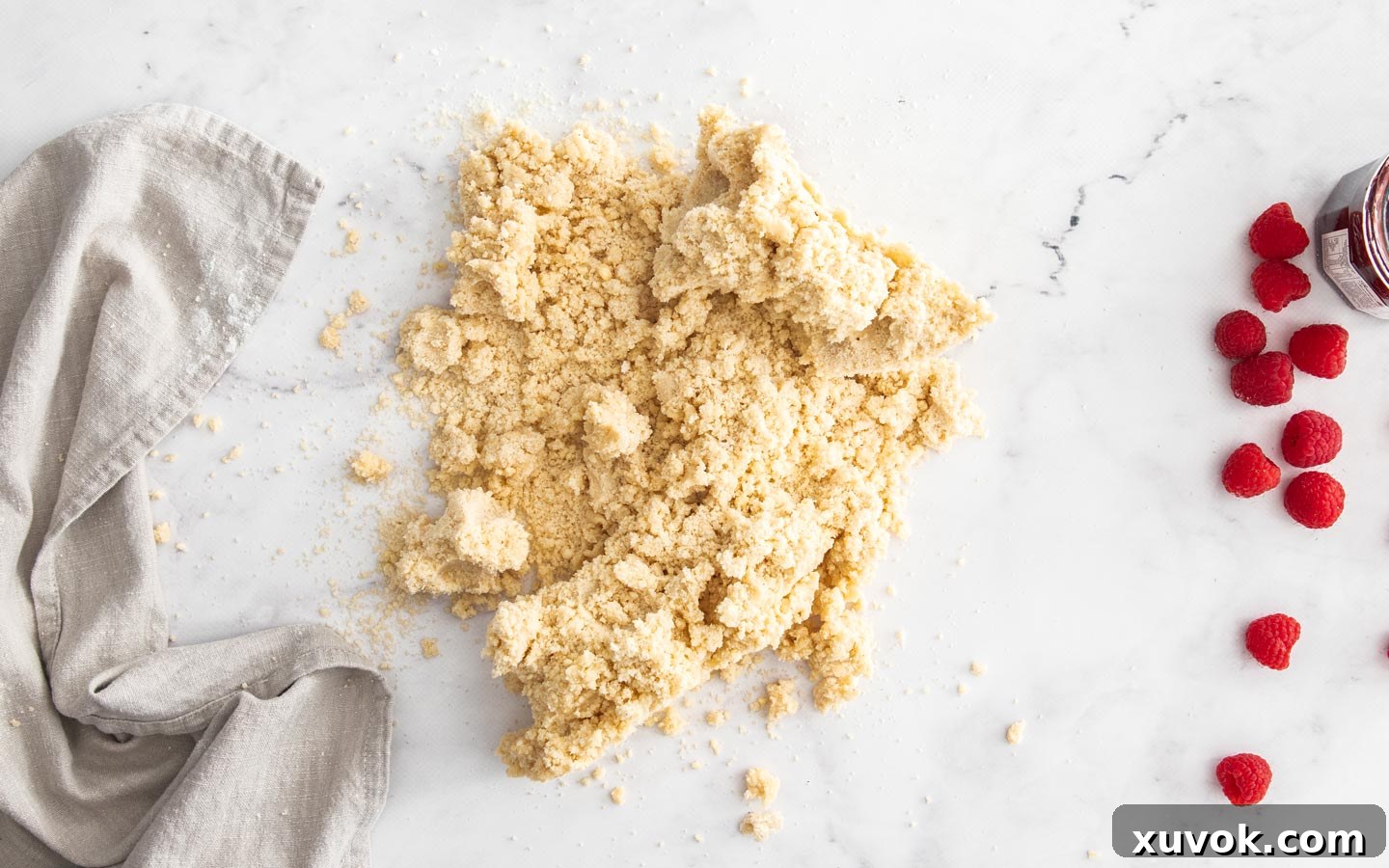 The crumbly dough on a marble surface.