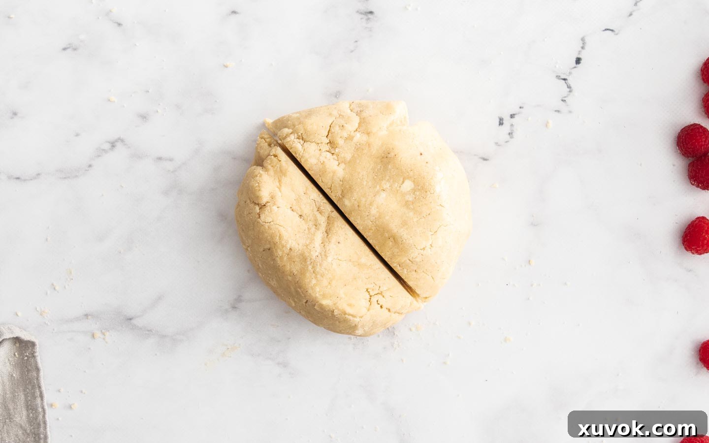 The dough in a ball, cut in half.