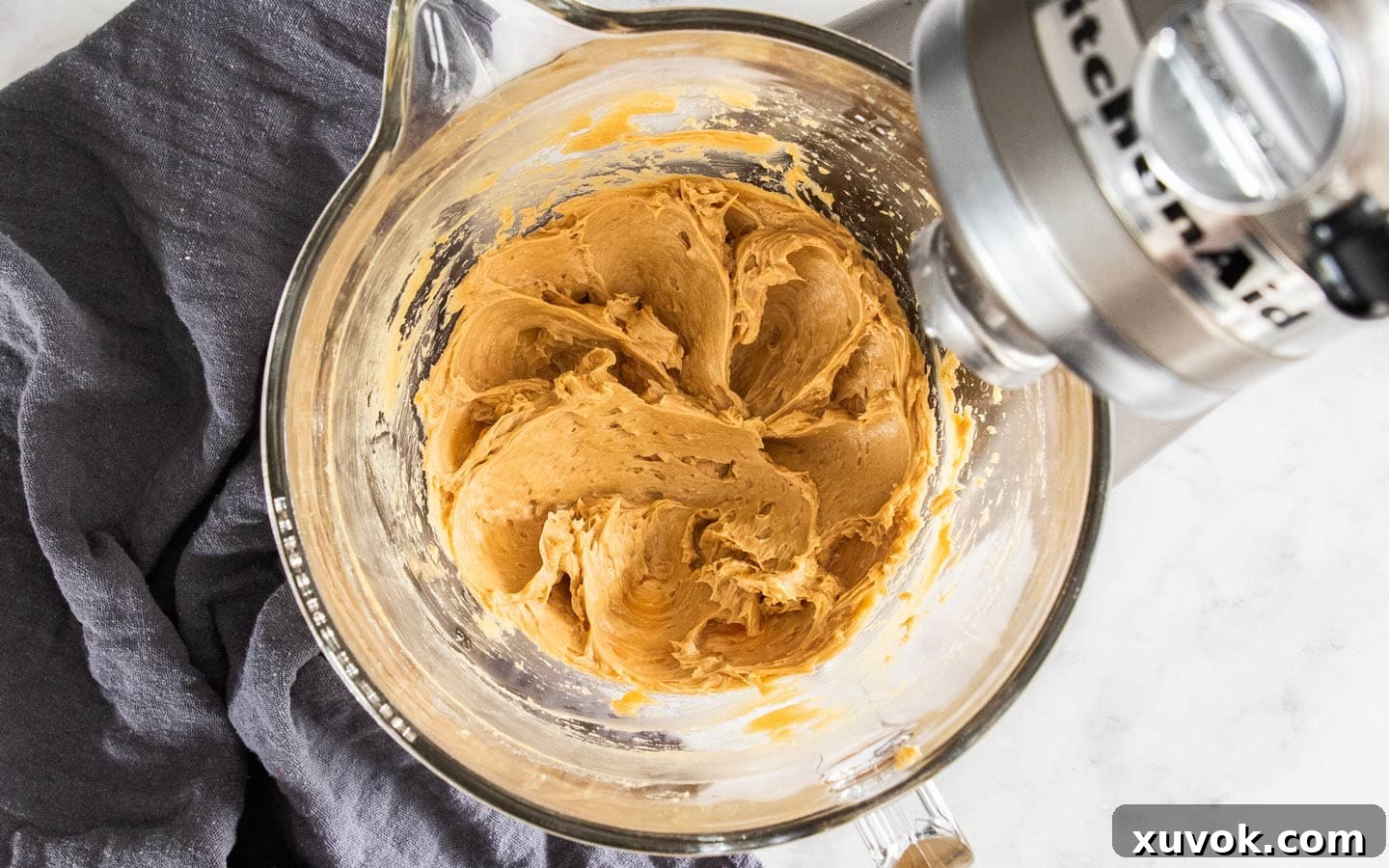 The buttercream after the caramel sauce has been smoothly beaten in, resulting in a rich, golden, and perfectly combined frosting.