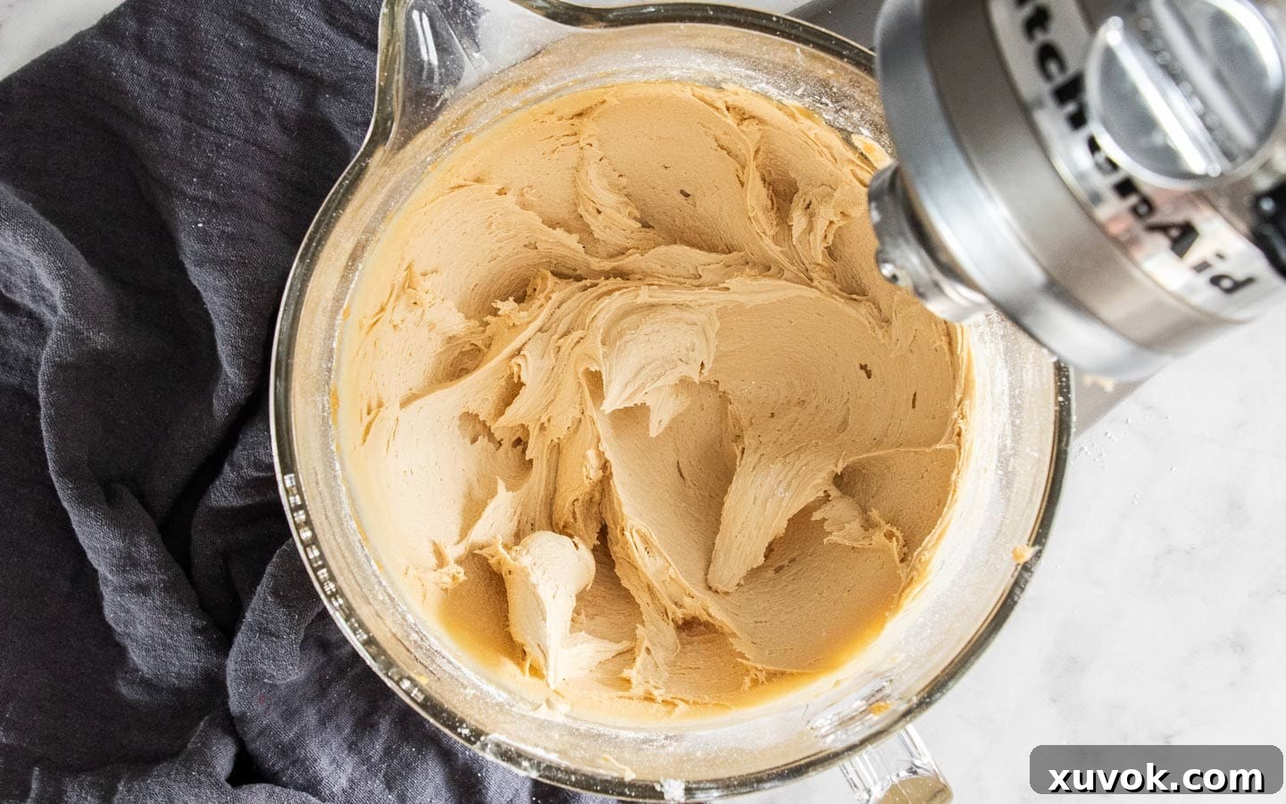 The caramel buttercream, now complete, after the icing sugar and cream have been beaten in, showcasing its silky smooth and fluffy texture.