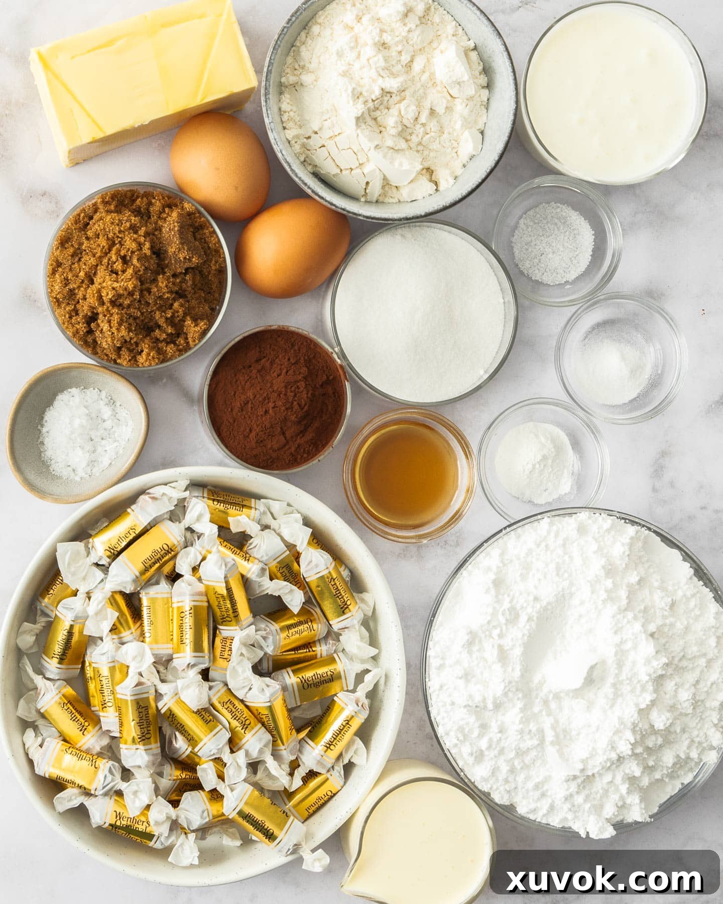 All the necessary ingredients meticulously laid out for baking delightful caramel chocolate cupcakes.