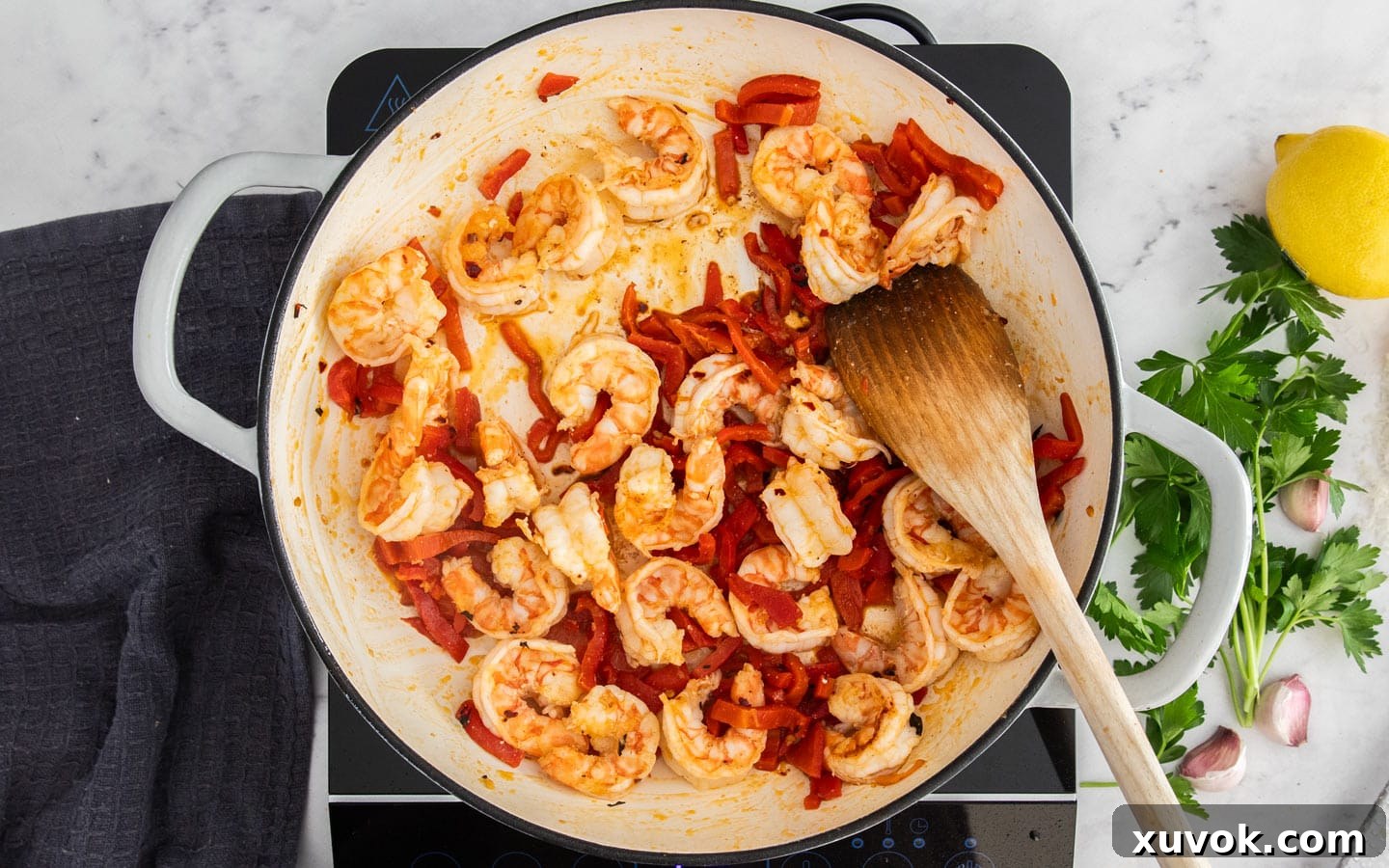 Prawns and roasted peppers in the pan cooking.