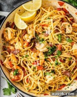 Top down view of the prawn and chorizo pasta in an enamel pan.
