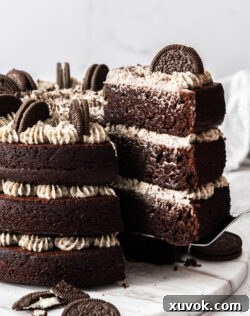 Closeup of a slice of Oreo chocolate cake being taken from the cake.