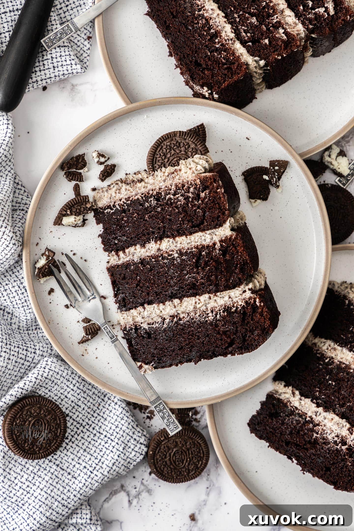 Top down view of a slice of Oreo chocolate cake on a dessert plate.