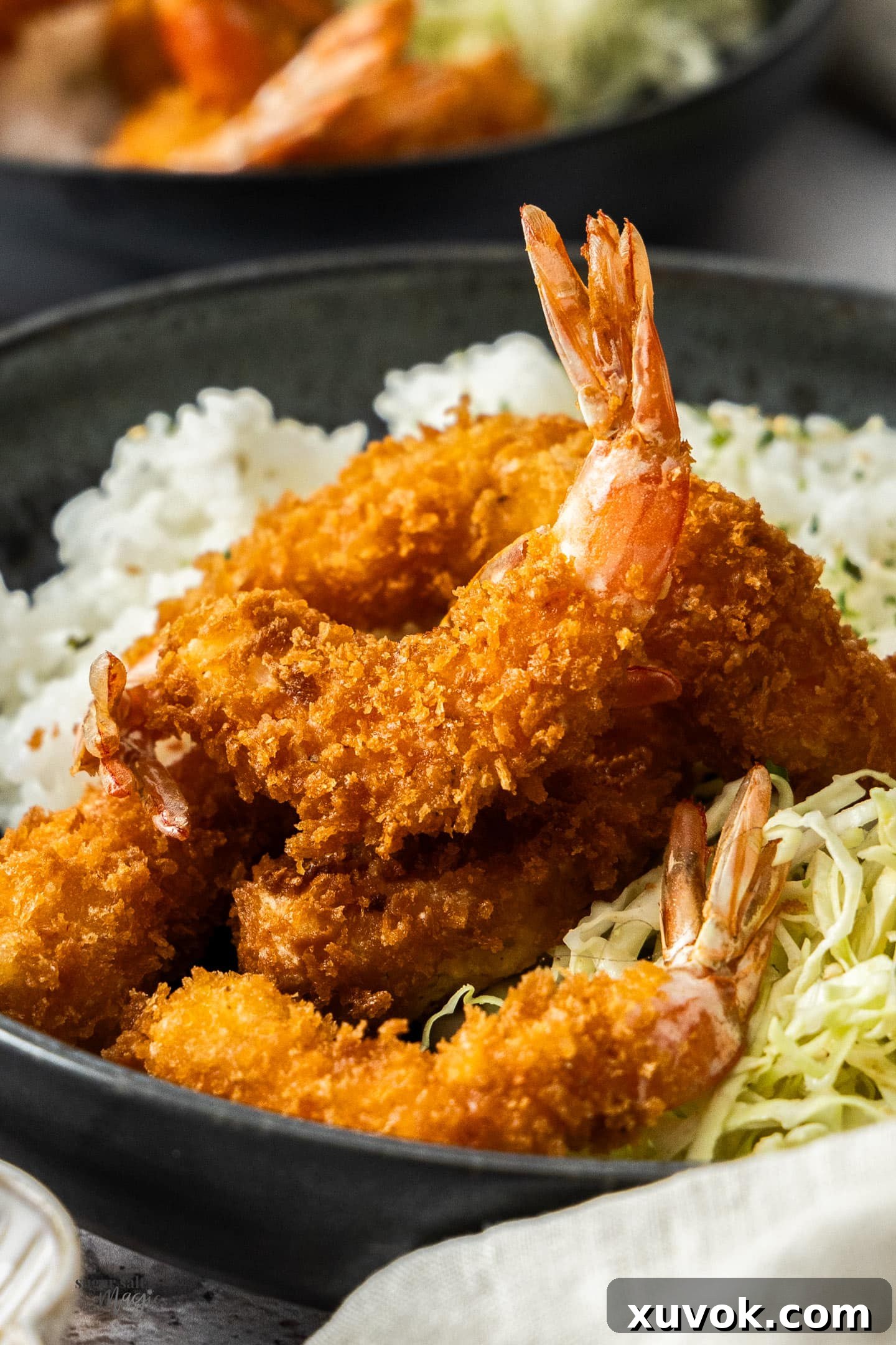 Closeup of a crispy prawn katsu, showcasing its golden-brown panko coating.