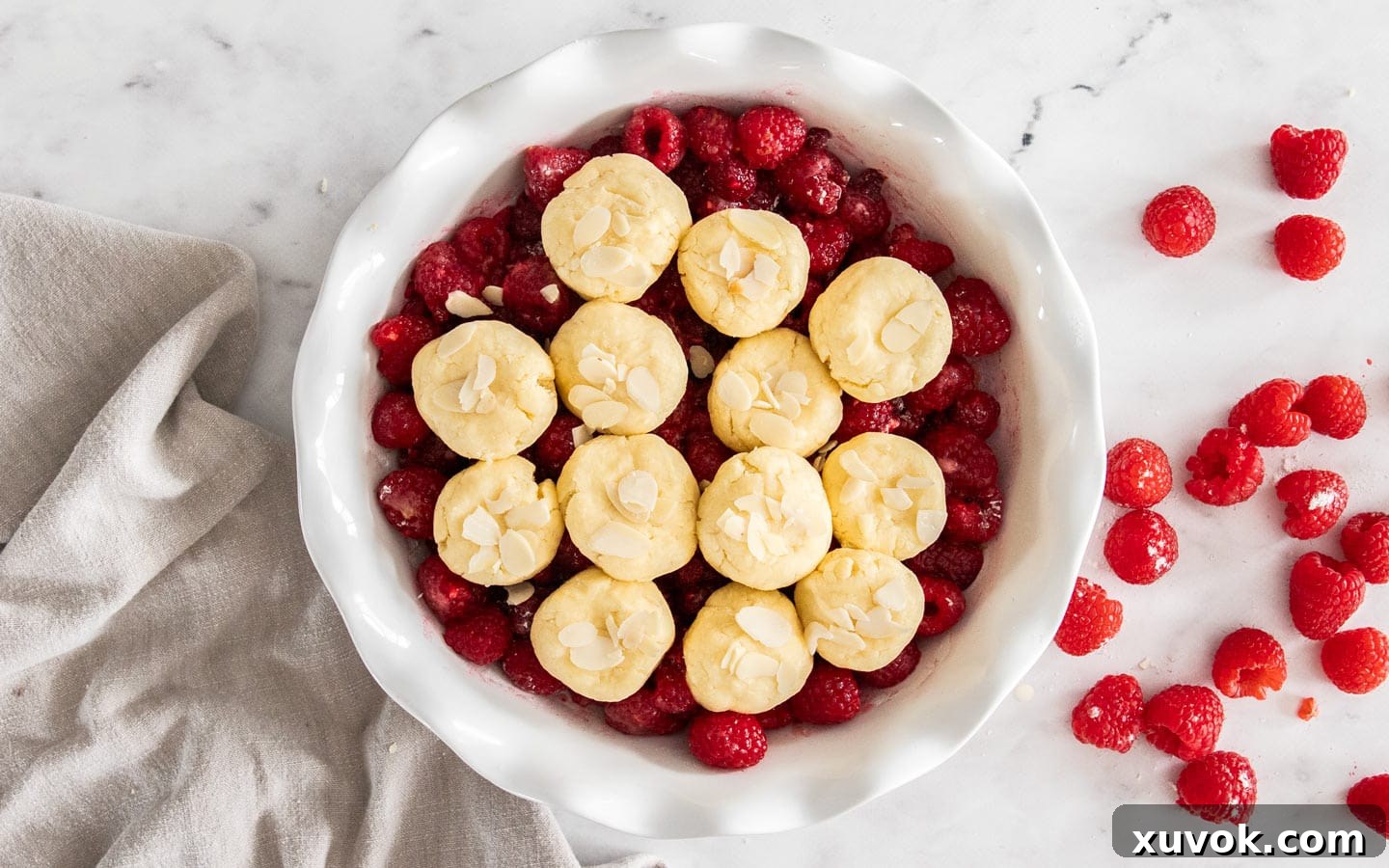 The raw biscuit topping on top of the raspberries.