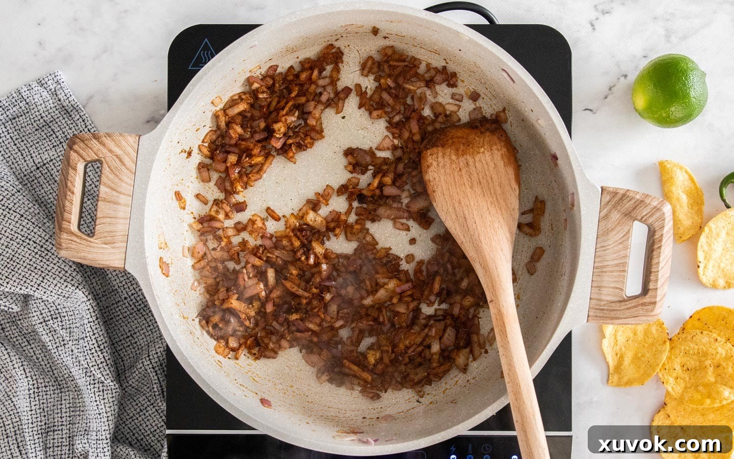 Onions, garlic, and spices cooking together in a pan, filling the kitchen with fragrant aromas.