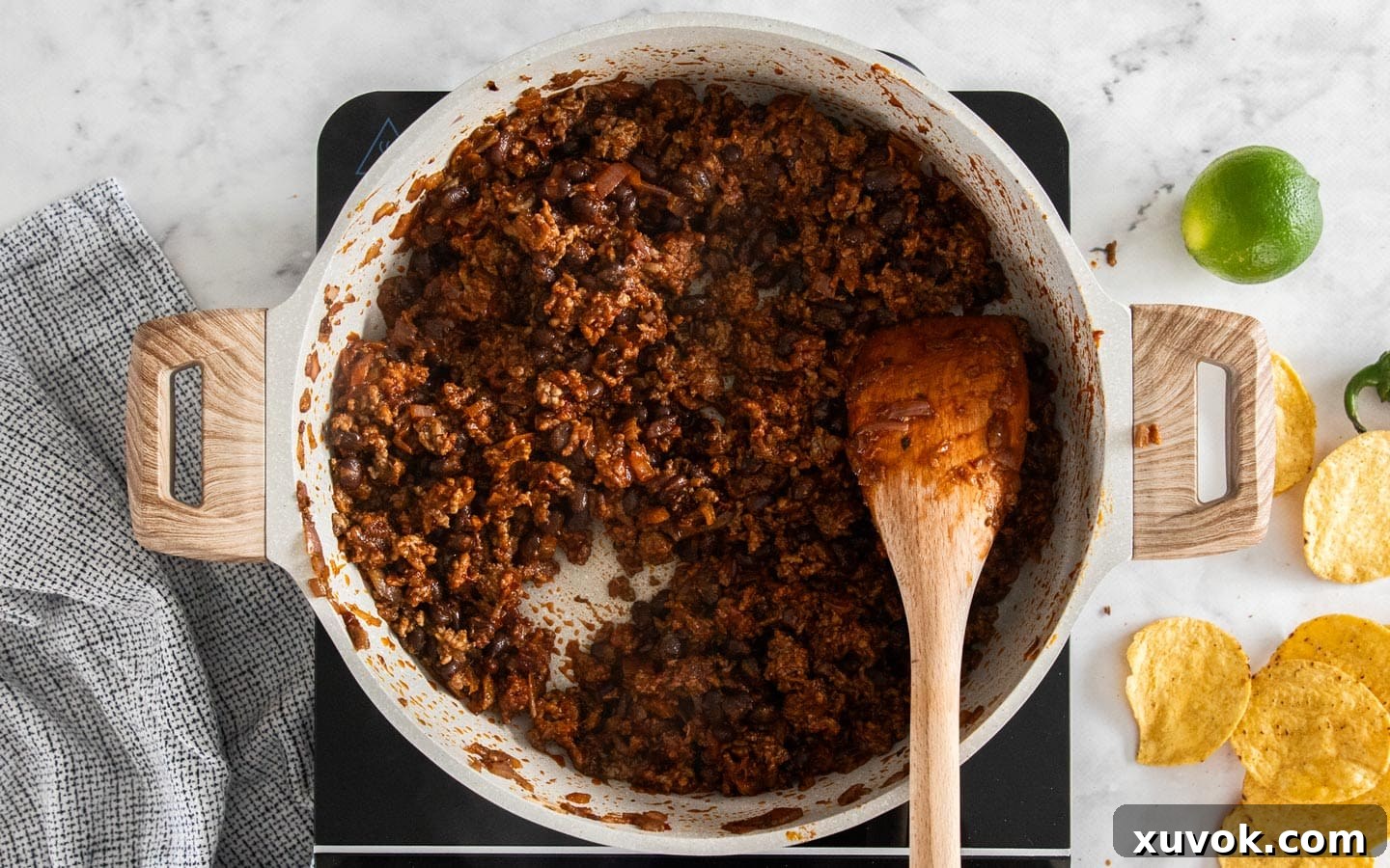 The finished chilli beef mixture, rich and saucy, ready to be layered onto nachos.