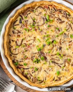 Top down view of a caramelised onion quiche with a golden crust and rich filling.