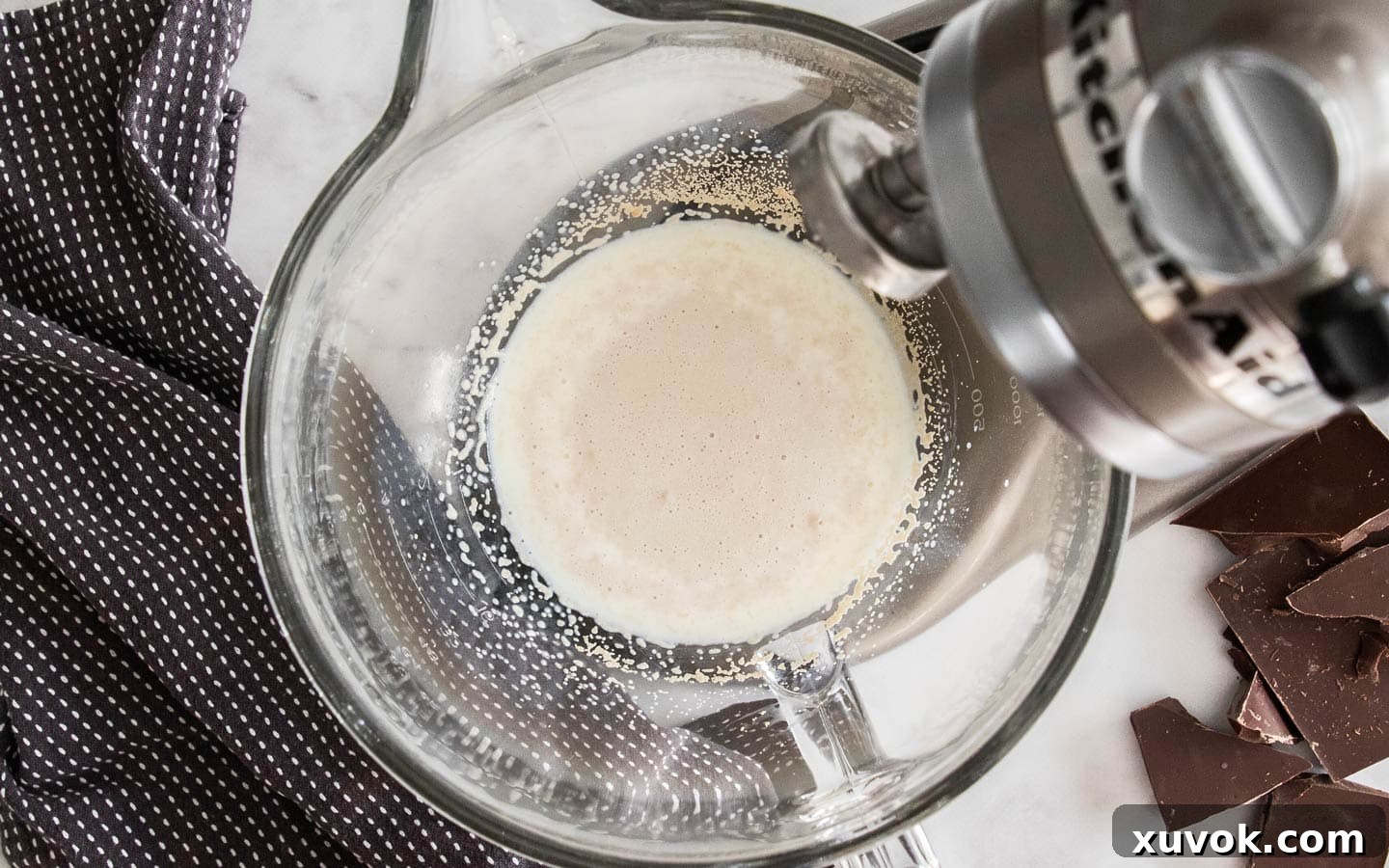 Yeast and milk in a mixing bowl.